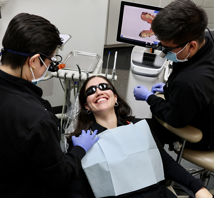 Woman in dental chair smiling at her San Antonio dentist