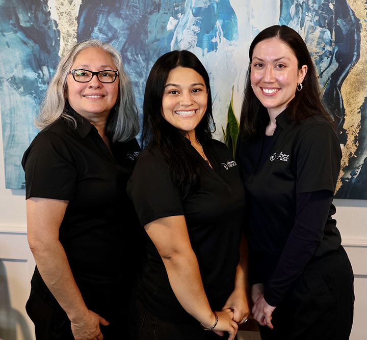 Three smiling San Antonio dental team members at Bianca Sanchez D D S