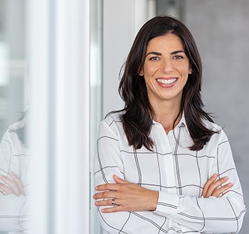 Woman leaning against window and smiling