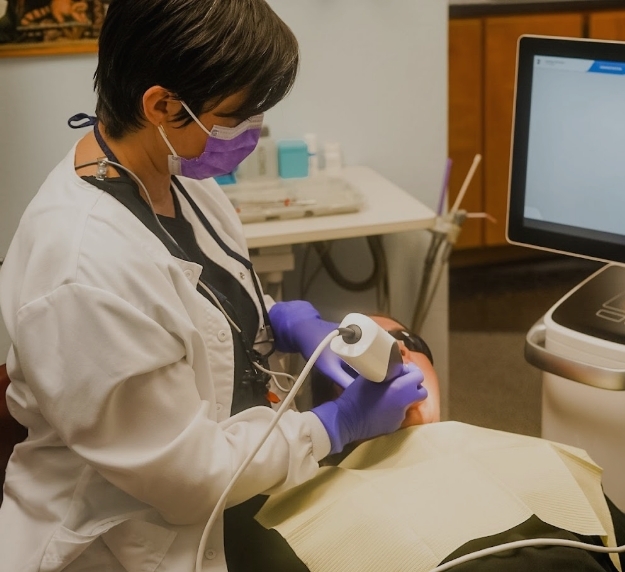 San Antonio dentist taking digital impressions of a patients teeth