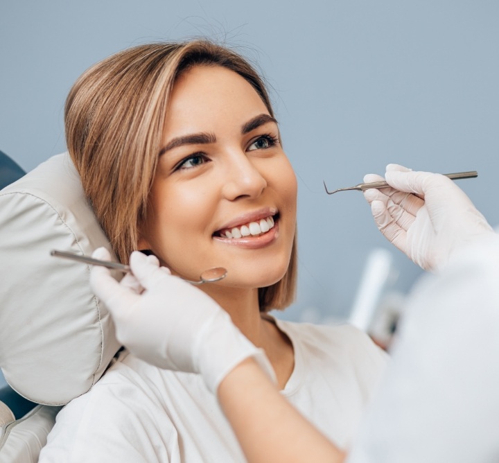 Woman smiling at her dentist during a preventive dentistry checkup in San Antonio